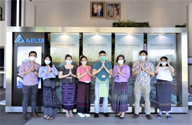 Delta Thailand 360 Editorial Team celebrating the Loy Krathong festival in traditional Thai costumes